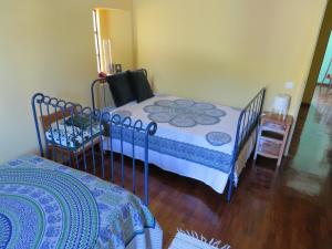 a bedroom with a bed and a wooden floor at Casa São João in São João da Serra