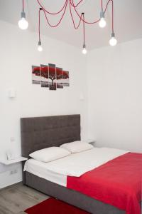 a bedroom with a bed with a red blanket at Deluxe Apartment in old city center in Lviv