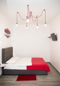 a bedroom with a bed with a red blanket at Deluxe Apartment in old city center in Lviv