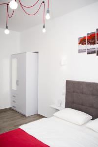 a bedroom with a bed and a white cabinet at Deluxe Apartment in old city center in Lviv +10 photos
