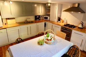 a kitchen with a table with a basket of food on it at The Pigeon Loft in Hurst Green
