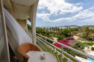 a balcony with a table and a view of a resort at Hotel Simius Playa in Villasimius