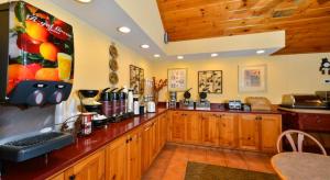 a kitchen with wooden cabinets and a counter top at Baymont by Wyndham Sevierville Pigeon Forge in Sevierville