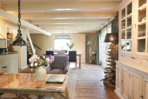 a living room with a table and a dining room at Lindenhof in Garderen
