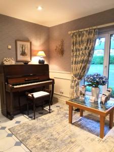 a living room with a piano and a table at Sea Dew B&B in Tullamore