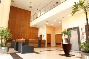 a lobby of a hospital with potted plants at Travel Inn Hotels Ibirapuera in Sao Paulo