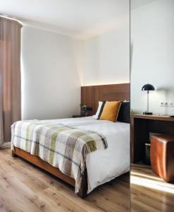a bedroom with a large bed with a wooden floor at Umi Hotel in Skogar