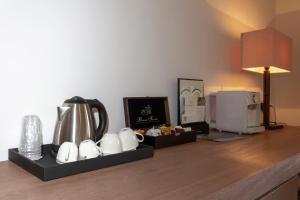a hotel room counter with a coffee maker and a microwave at Hotel Simius Playa in Villasimius
