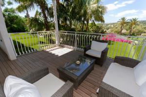 a patio with chairs and a coffee table on a deck at Hotel Simius Playa in Villasimius