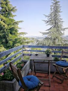 a patio with two chairs and a table with a view at Il Giardino dei Frati in Roncofreddo