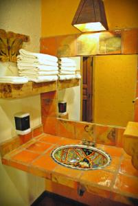 a bathroom counter with a sink and a mirror at Hotel Hacienda Don Juan in San Cristóbal de Las Casas +62 photos