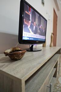 a television sitting on top of a counter with a bowl at Maria Court 2, Apt 32 in Larnaca