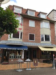 a large red brick building with white windows at 27 Vestergade in Tønder
