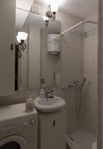 a bathroom with a sink and a shower at Atelje Knez Mihailova in Belgrade