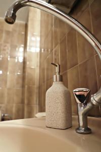 a soap dispenser sitting on a bathroom sink at Maria Court 2, Apt 32 in Larnaca