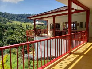 a balcony of a house with a view at Lodge Paraíso Verde in Manizales