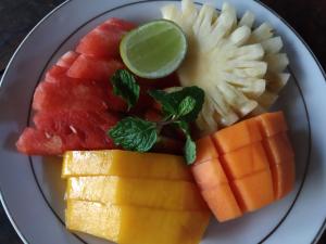 a plate of fruit and vegetables on a plate at Jempiring Homestay in Ubud