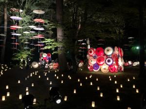 a group of candles in a park at night at kinugawaonsen Fukumatsu in Nikko