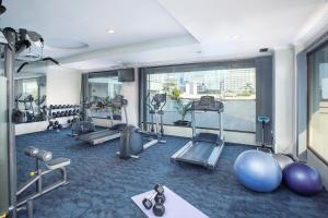 a gym with exercise equipment and a large window at Royal Kuningan in Jakarta