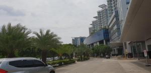 a car parked on a street with palm trees and buildings at Mactan Newtown Ocean View 360 Degree in Mactan