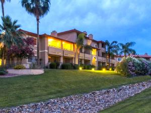 a large building with palm trees and a yard at Gated Mountain View Resort Community, Centrally Located, Three Heated Pool-Spa Complexes, Half-Mile To Hiking! in Phoenix