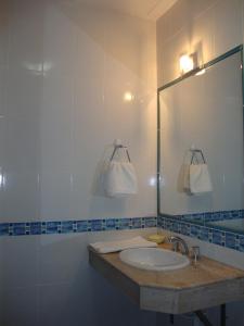 a bathroom with a sink and a mirror at Hotel Granny in Tarija