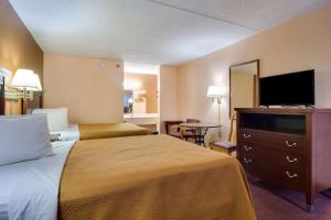 um quarto de hotel com duas camas e uma televisão de ecrã plano em Motel 6-Macon, GA em Macon