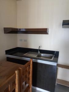 a kitchen with a sink and a counter top at Vimelzu Mhavic guest room in Manila