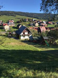 a small town in a green field with houses at Rekreačný dom Chata Piero in Ždiar