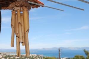 a bunch of wooden sticks hanging from a roof at Jenny's house,Agiou Ioannou 103 in Artemida