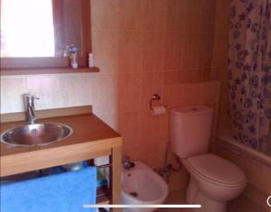 a bathroom with a sink and a toilet at A Coruña al lado de la playa in Bastiagueiro