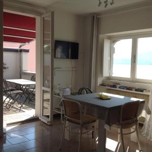 a kitchen and dining room with a table and chairs at Casa Mary Varenna in Varenna
