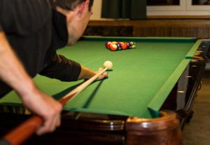a man is playing a game of pool at Ferienhaus Bergesblick in Lam
