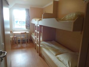 A bed or beds in a room at Jugendgästehaus St. Gilgen