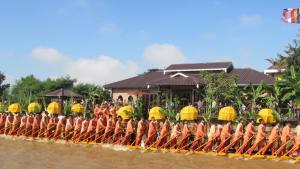 a group of people on a boat in the water at Thanakha Inle Hotel in Nyaungshwe Township