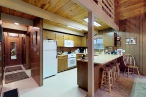 a kitchen with white appliances and wooden cabinets at Bears Meadow in Arnold