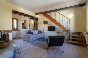 a living room with a couch and a staircase at Apartments Florence - Duomo in Florence