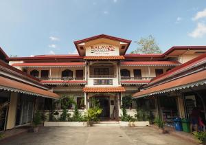 a building with a sign on the front of it at Balay Travel Lodge in Paoay
