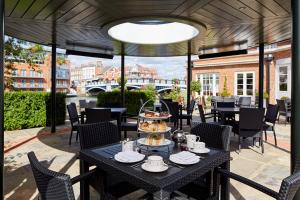 a table with a tray of food on a patio at Sir Christopher Wren Hotel in Windsor