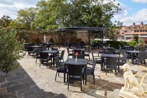 a group of tables and chairs in a patio at Sir Christopher Wren Hotel in Windsor