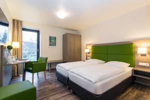 Postel nebo postele na pokoji v ubytování Hotel Holzscheiter