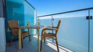 a table and chairs on the balcony of a room at Luxury apartment on Icod de los Vinos in Icod de los Vinos