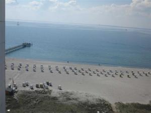 a beach with a bunch of chairs and a pier at Herrmann Jens in Pelzerhaken +16 photos