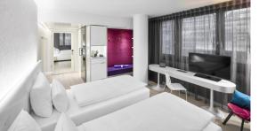 a living room with a white couch and a television at Jaz in the City Stuttgart in Stuttgart