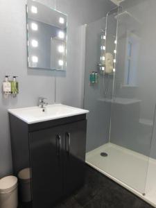 a bathroom with a sink, mirror, and toilet at Cullen Bay Hotel in Cullen