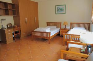 Postel nebo postele na pokoji v ubytování Shuang Liou B&B