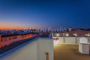 a view from the roof of a building at night at Apartamentos Obelisc in Can Picafort
