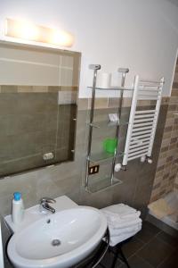 a bathroom with a sink and a glass shower at B&B Novecento in Palermo
