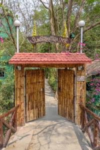 a wooden gate with a sign that reads superstar her café at Sunderban Tiger Camp in Gosāba