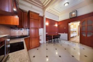 a kitchen with wooden cabinets and a table in it at Hostel Suputnyk in Lviv